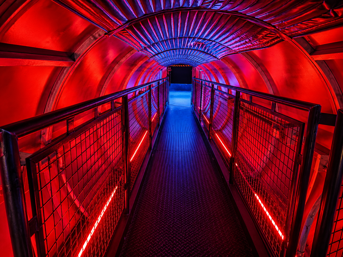 Vibrant red and blue illuminated pedestrian tunnel